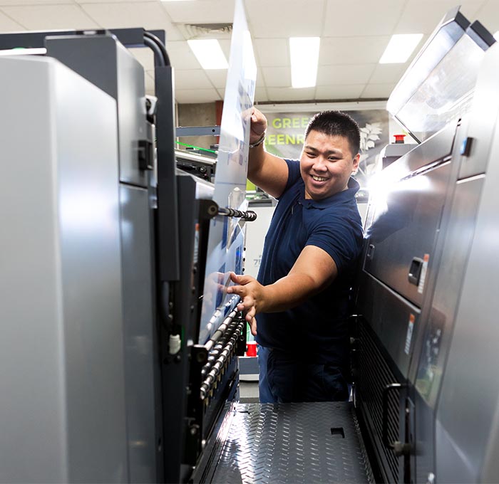 Greenridge Group team member using printing press